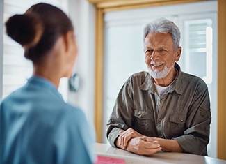 Patient and dental team member standing at front desk