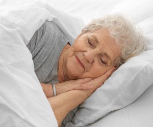 Senior woman sleeping peacefully in bed