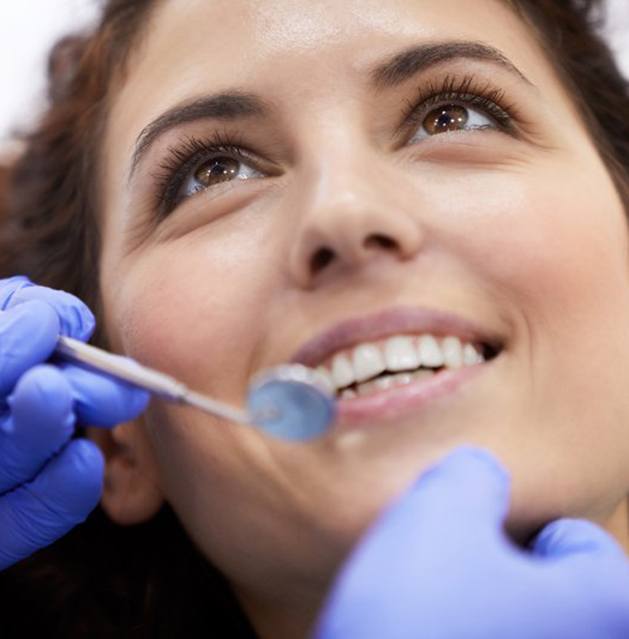 a patient smiling while undergoing a dental checkup