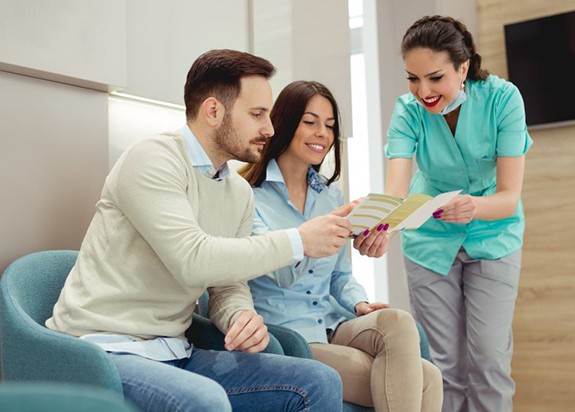 a couple talking to a front desk team member