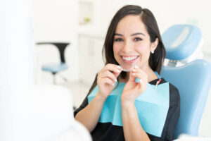 Smiling woman in dentist’s chair for Invisalign